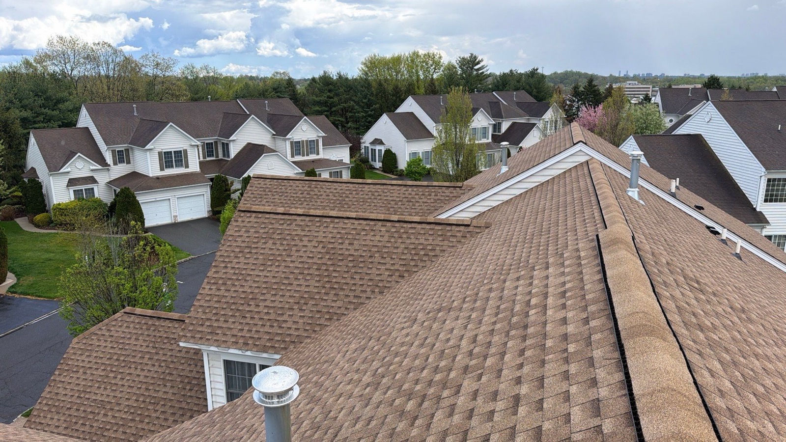Completed suburban roof replacement — clean GAF shingles edge to edge