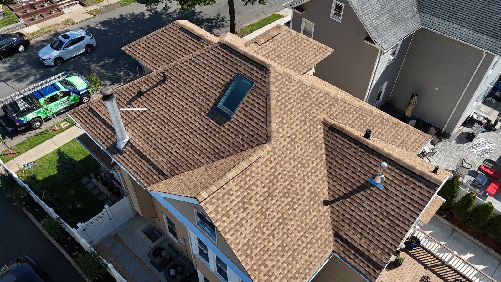 Completed Victorian with new tan shingle roof showing all dormers