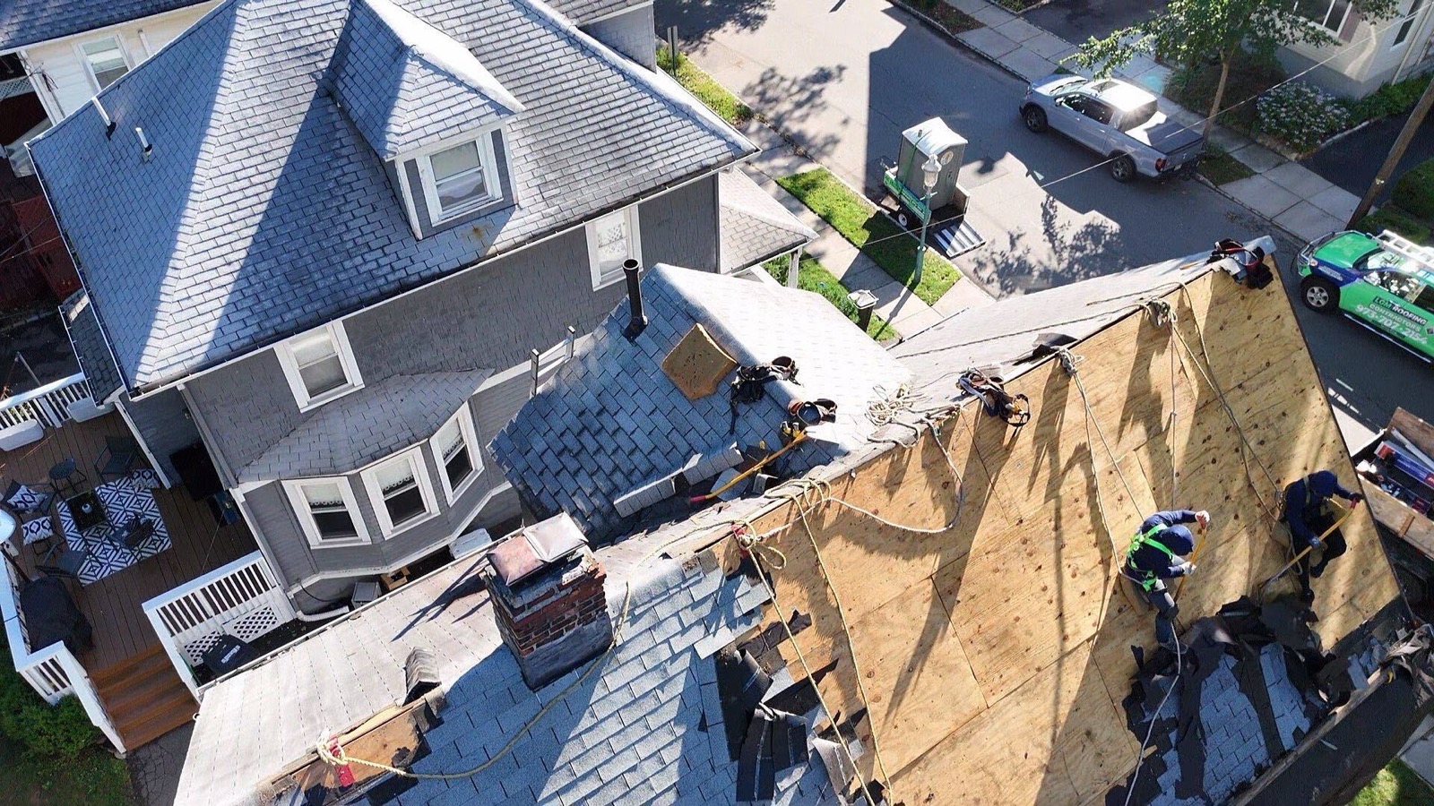 Drone view of LGM crew resheathing a roof with new plywood
