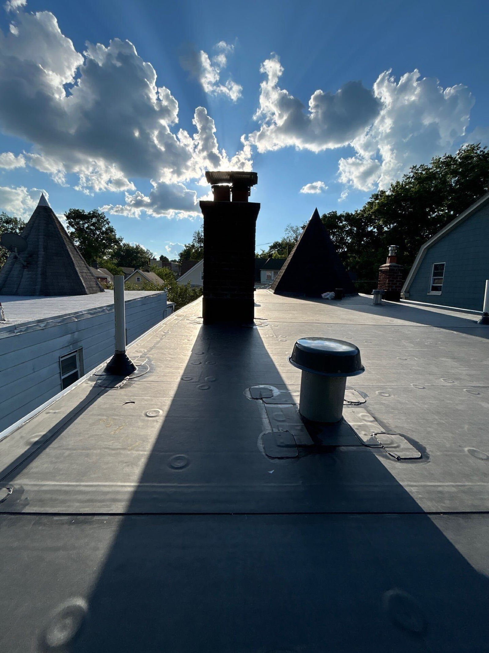 Completed EPDM flat roof silhouetted at sunset over North Jersey