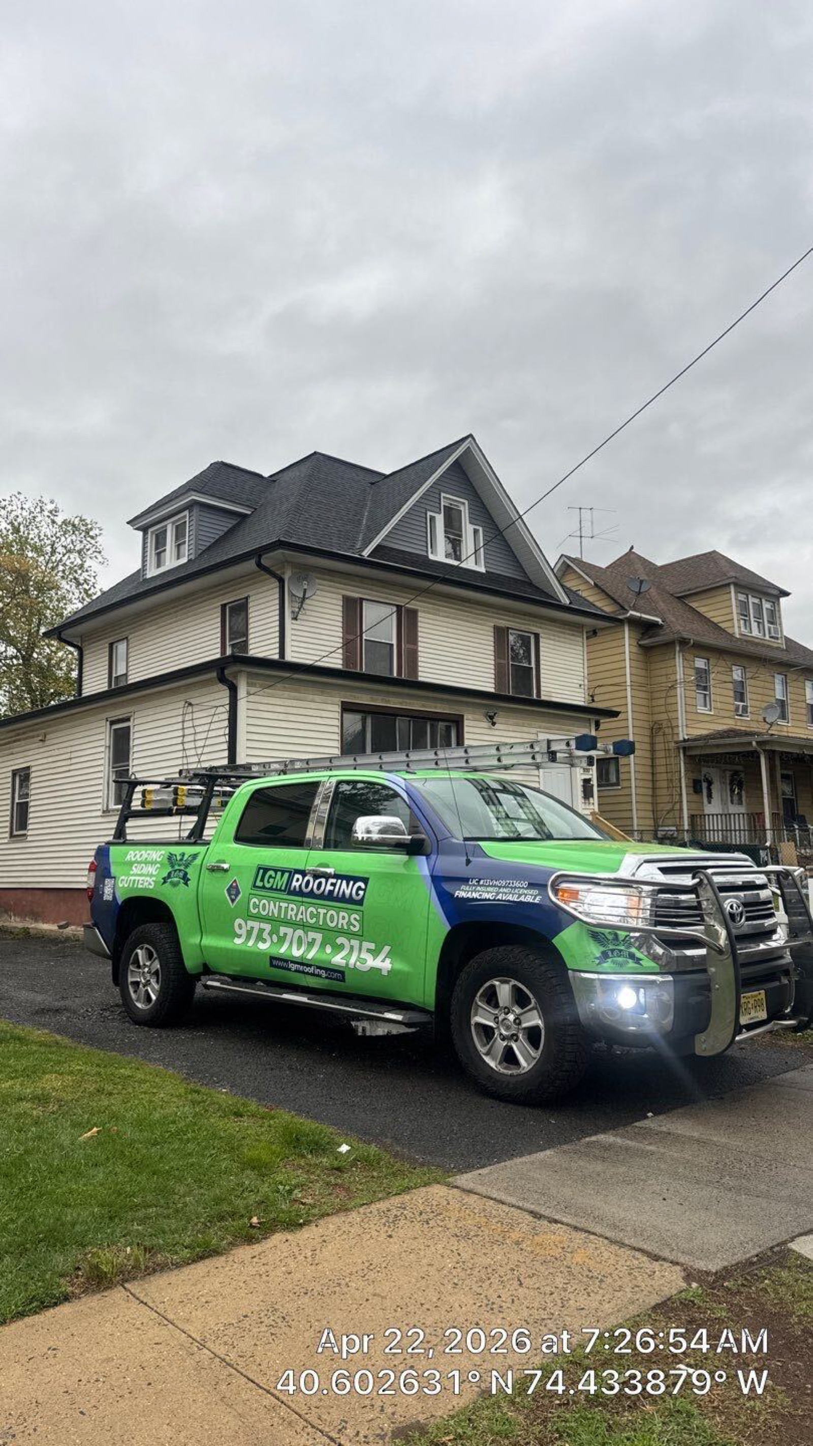 LGM Roofing branded truck with full wrap at a job site