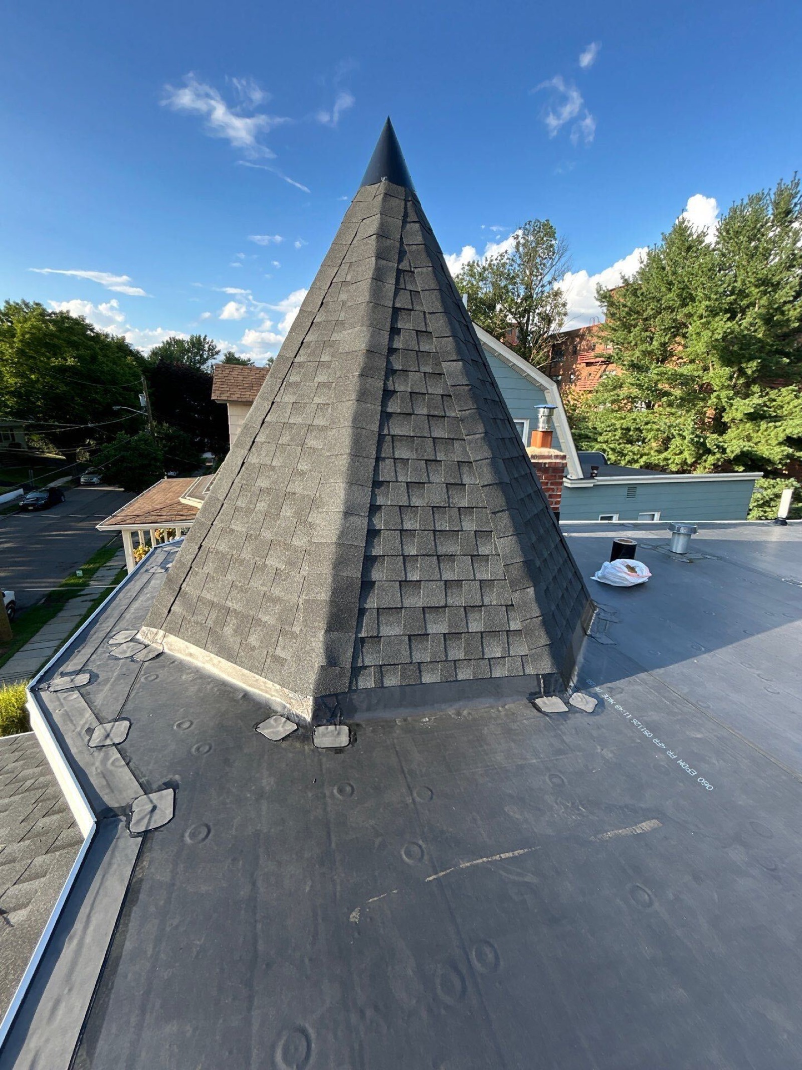 Shingled turret meeting an EPDM flat section — specialty work